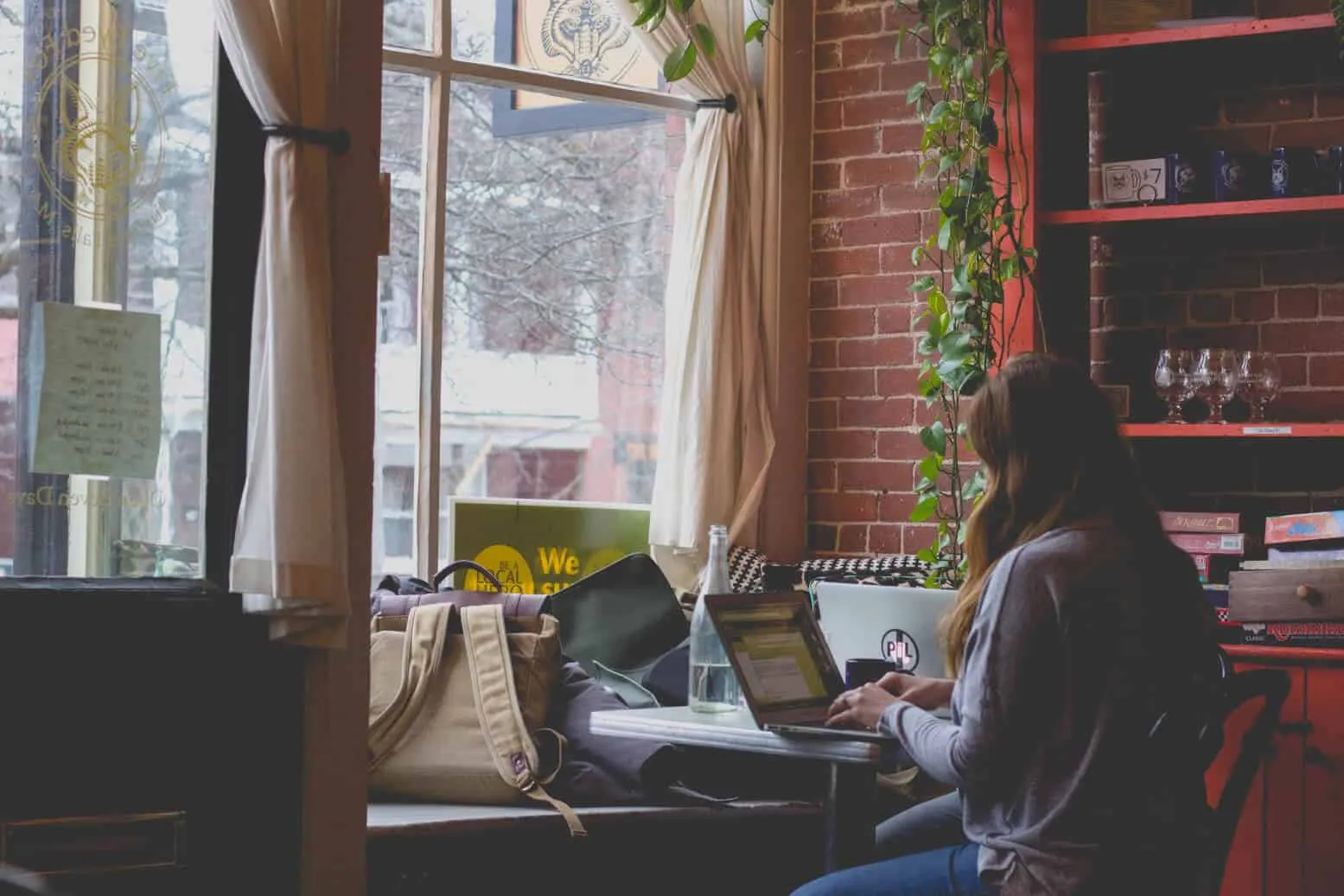 Freelancer working on a laptop in a coffee shop